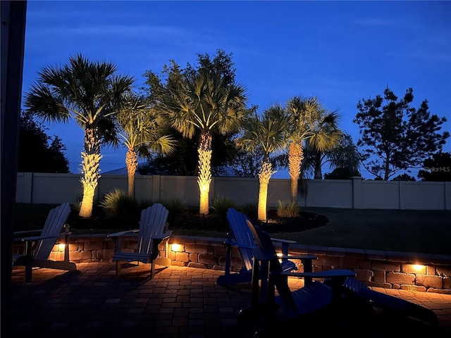 patio at twilight featuring an outdoor fire pit