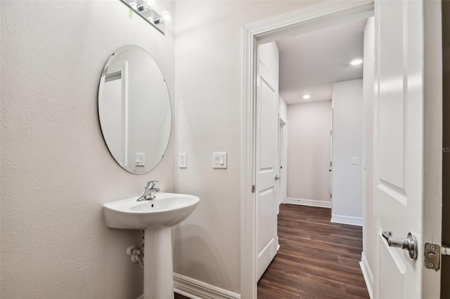 bathroom with hardwood / wood-style floors