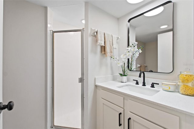 bathroom featuring vanity and an enclosed shower