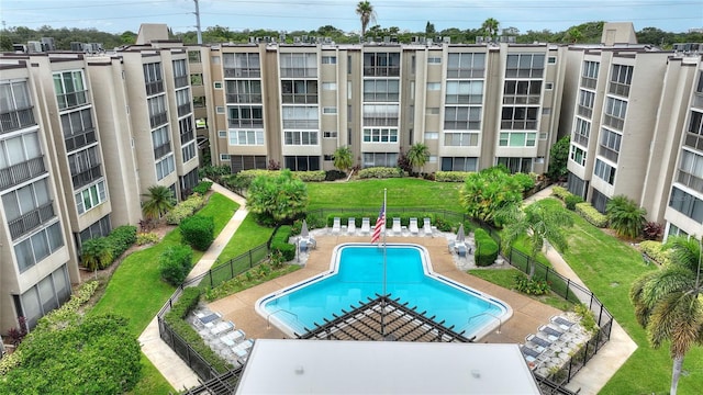 view of swimming pool with a lawn