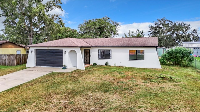 single story home with a front yard and a garage