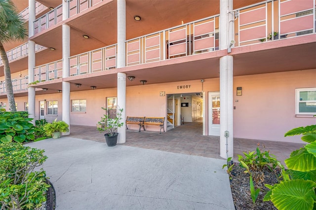 entrance to property with a balcony and a patio