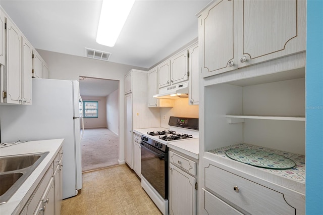 kitchen with white cabinetry, white appliances, and light colored carpet