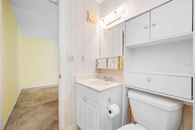 bathroom featuring toilet and vanity