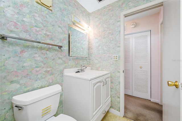 bathroom with toilet and vanity