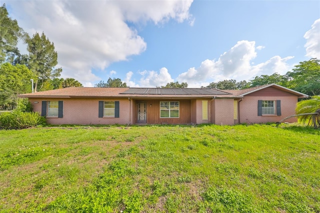 ranch-style home with a front lawn