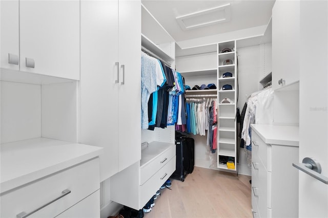 walk in closet featuring light hardwood / wood-style flooring