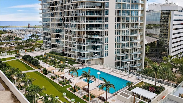 view of property with a community pool and a water view