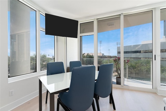 175 1st St S Unit 406, Saint Petersburg, FL 33701 - dining area featuring wood finished floors, baseboards, and expansive windows