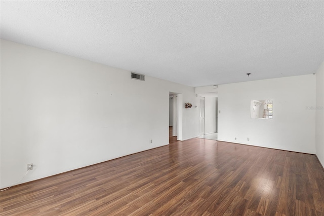 unfurnished room with a textured ceiling and hardwood / wood-style flooring