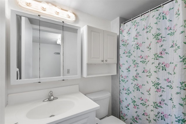 bathroom with vanity, toilet, and a shower with shower curtain