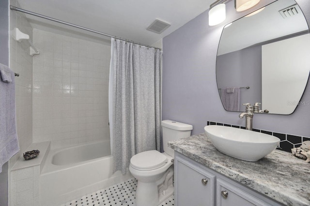 full bathroom featuring vanity, shower / tub combo with curtain, and toilet