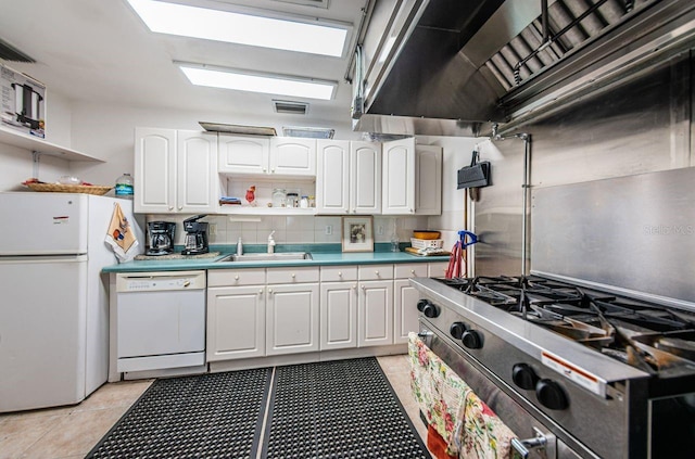 kitchen with white cabinets, tasteful backsplash, light tile patterned floors, sink, and white appliances