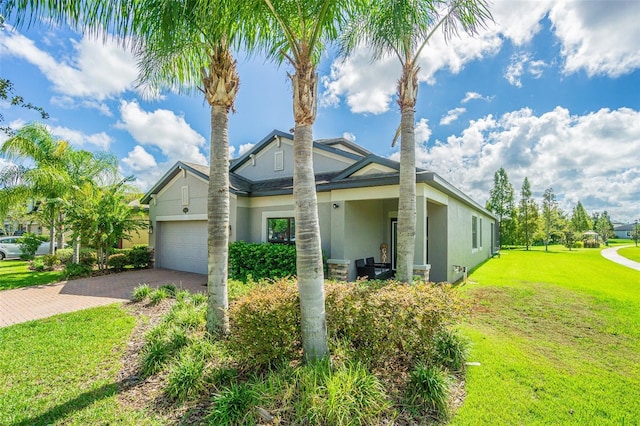 19501 Sea Myrtle Way, Tampa, FL 33647 - view of front of home with stucco siding, driveway, a front yard, and a garage