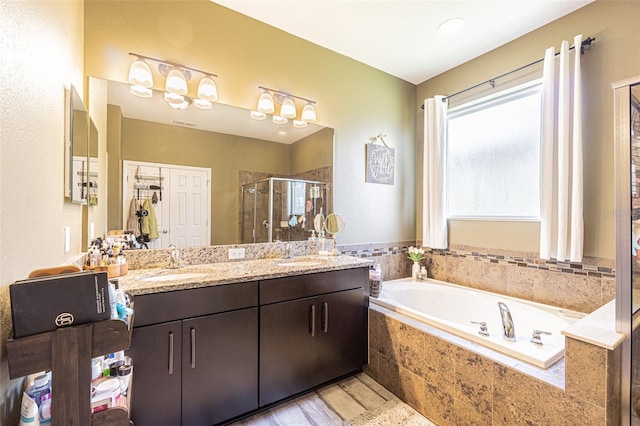 bathroom with vanity, wood-type flooring, and plus walk in shower