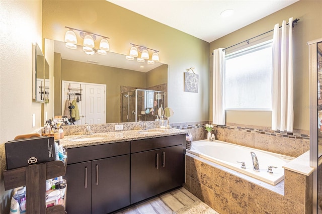 19501 Sea Myrtle Way, Tampa, FL 33647 - bathroom featuring a shower stall, a garden tub, double vanity, and wood finished floors