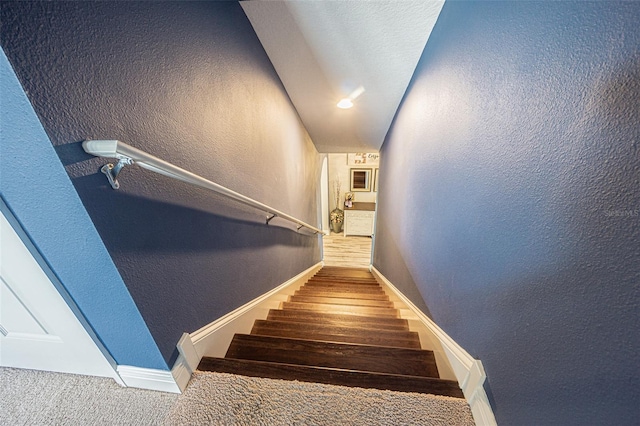 19501 Sea Myrtle Way, Tampa, FL 33647 - staircase featuring a textured wall, baseboards, and carpet floors