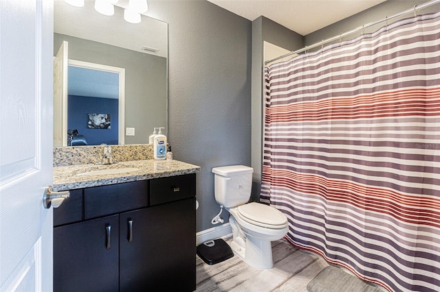 bathroom with vanity, toilet, a shower with shower curtain, and hardwood / wood-style floors