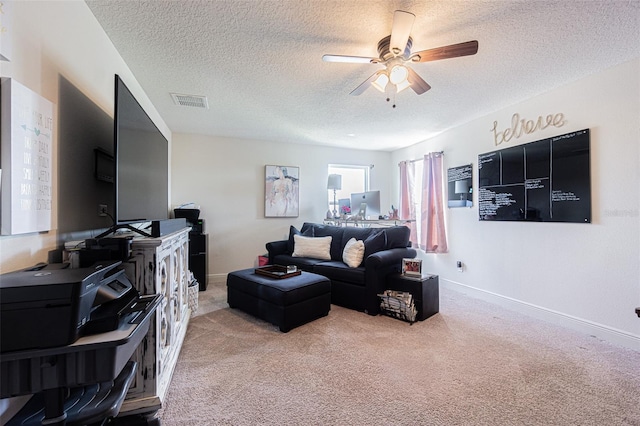 carpeted living room with a textured ceiling and ceiling fan