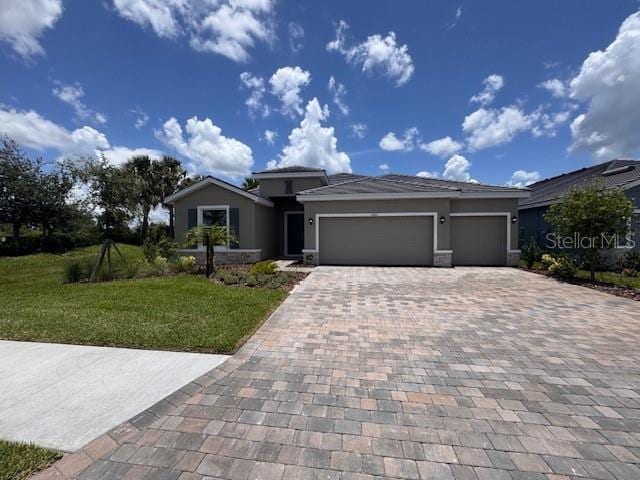 4303 Pullet Ct, Lakewood Ranch, FL 34211 - view of front facade featuring decorative driveway, an attached garage, a front yard, and stucco siding