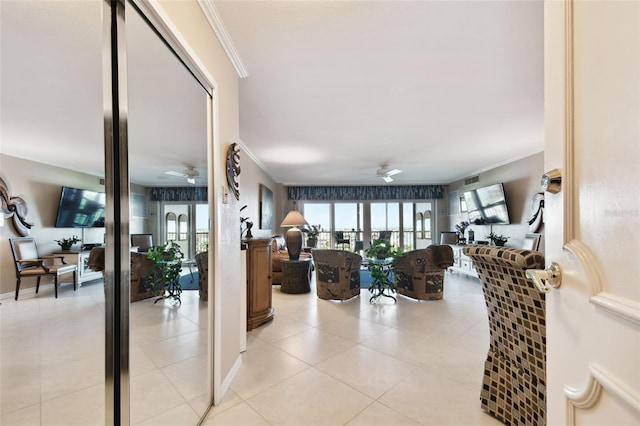 living room featuring crown molding, ceiling fan, and light tile patterned floors