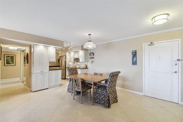 dining space with ornamental molding and light tile patterned flooring