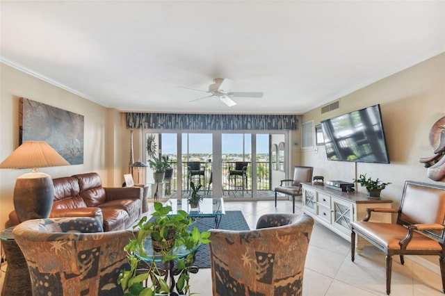 living area with light tile patterned floors, crown molding, a ceiling fan, and visible vents