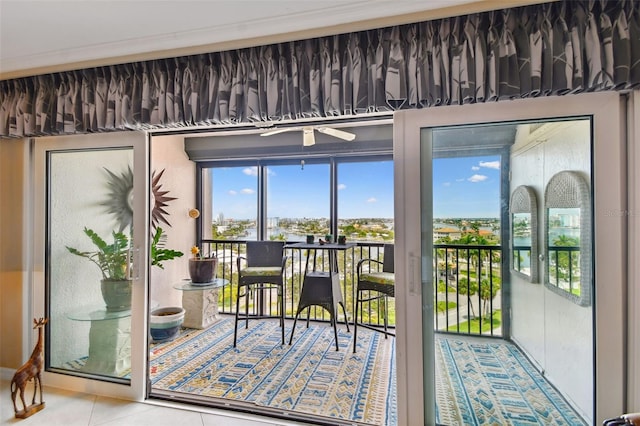 doorway to outside with ceiling fan and tile patterned floors