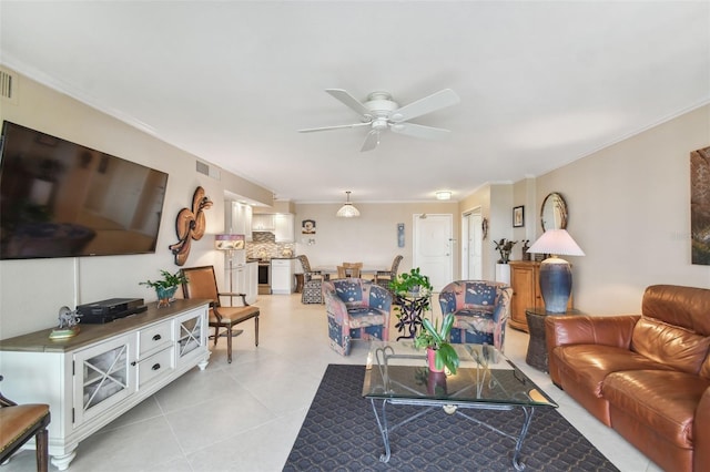 living area featuring visible vents, ornamental molding, and ceiling fan