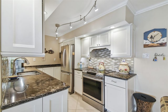 kitchen featuring appliances with stainless steel finishes, dark stone countertops, white cabinetry, crown molding, and sink