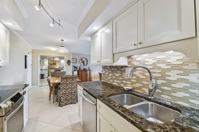 kitchen with stainless steel appliances, ornamental molding, decorative backsplash, and a sink