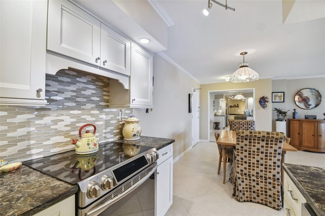 kitchen with decorative backsplash, white cabinetry, decorative light fixtures, dark stone counters, and stainless steel electric range oven