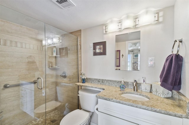 full bath with vanity, toilet, a textured ceiling, a shower stall, and visible vents