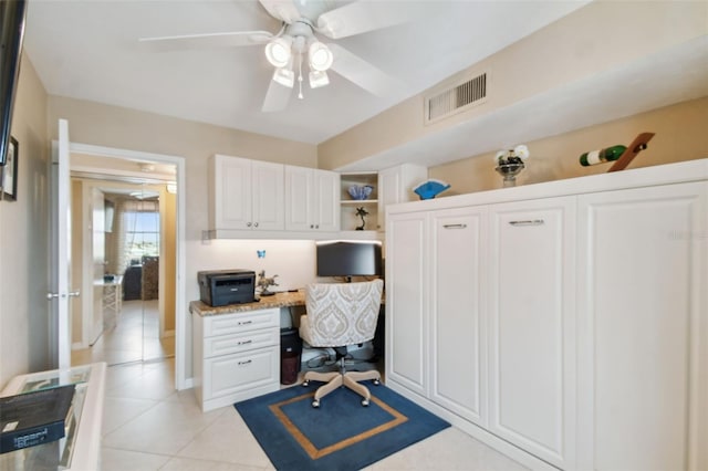 office space with ceiling fan, visible vents, light tile patterned floors, and built in study area