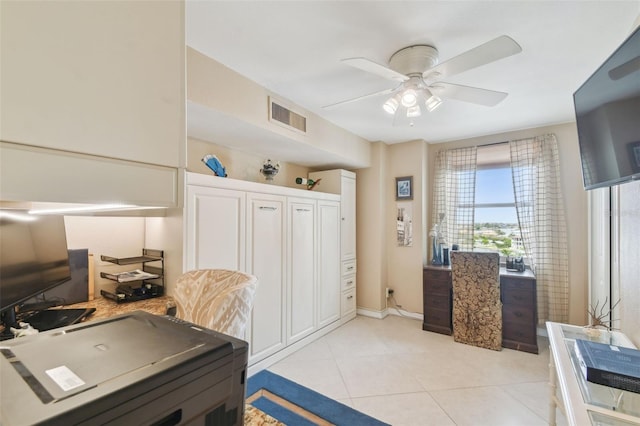 office area with visible vents, baseboards, ceiling fan, and light tile patterned floors