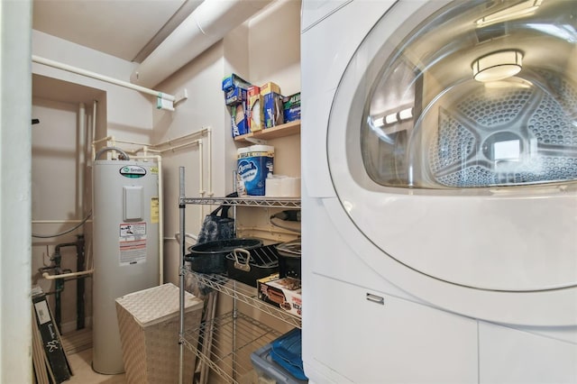 laundry room with water heater, tile patterned floors, and stacked washer and clothes dryer