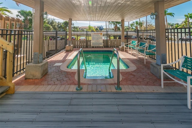 view of swimming pool featuring fence