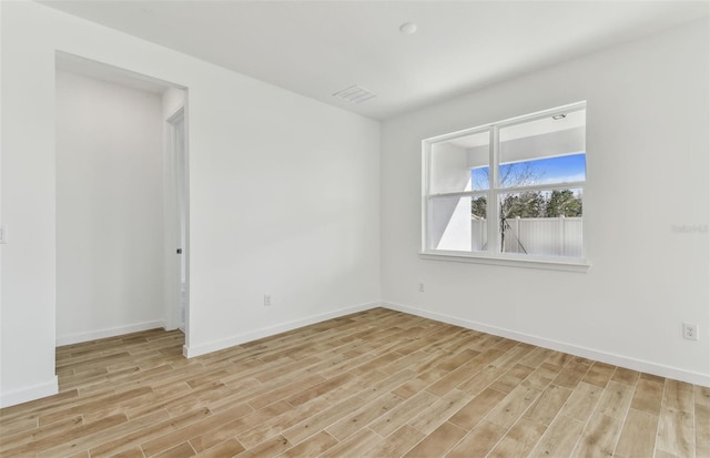 unfurnished room with light hardwood / wood-style flooring