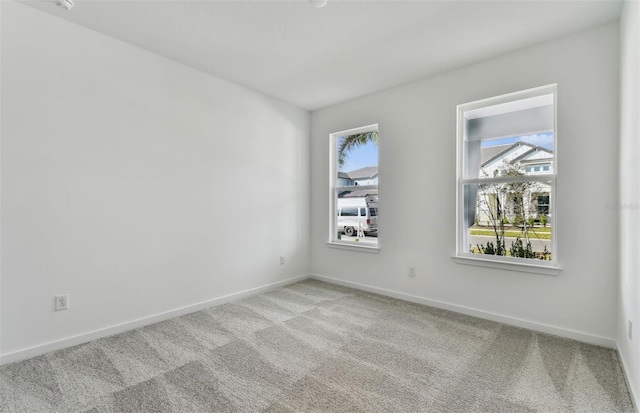 carpeted empty room featuring a healthy amount of sunlight