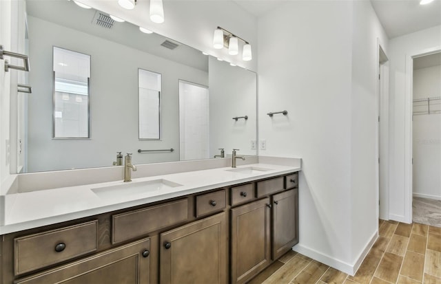 bathroom featuring a shower and vanity