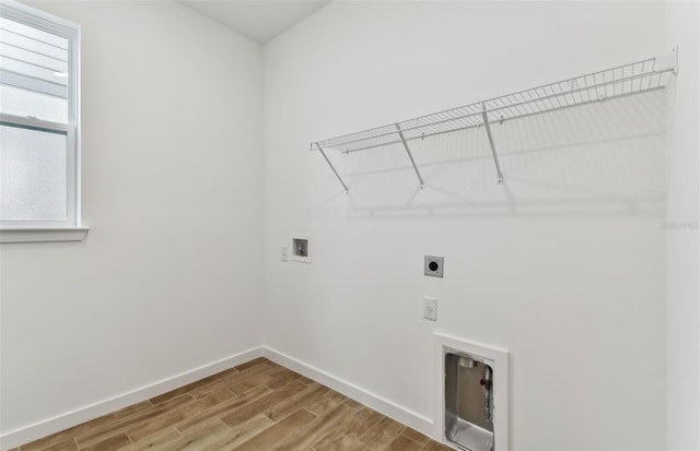 clothes washing area featuring hookup for an electric dryer, hookup for a washing machine, and wood-type flooring