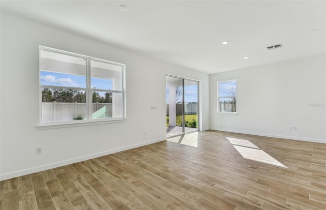 spare room with light hardwood / wood-style flooring