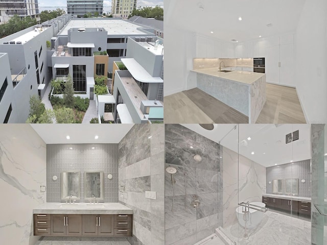 interior space with a tile shower and vanity