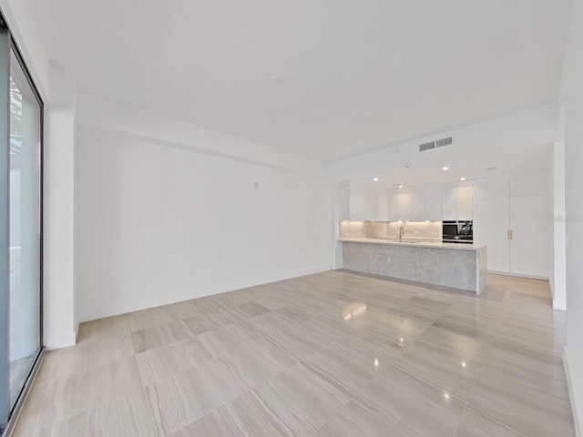 unfurnished living room with sink