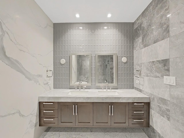 bathroom featuring vanity, tile walls, and an enclosed shower