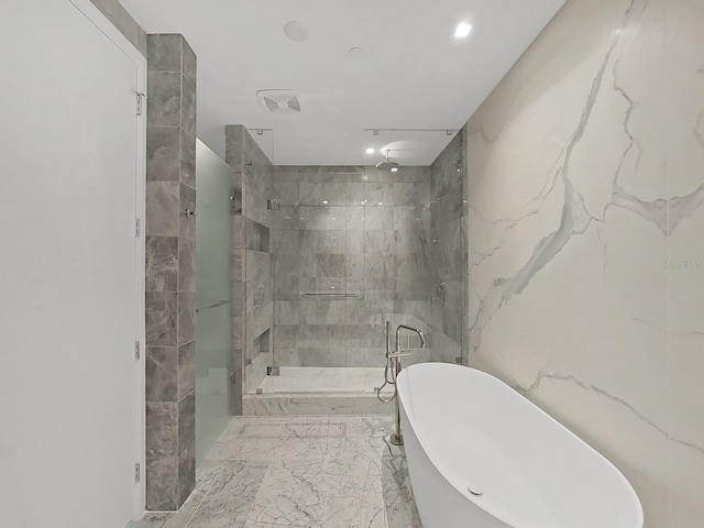 bathroom featuring shower with separate bathtub