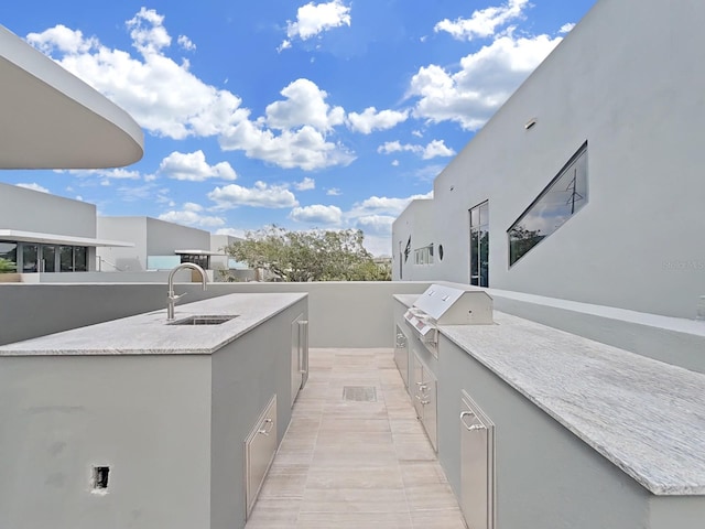 view of patio / terrace with an outdoor kitchen, a grill, and sink