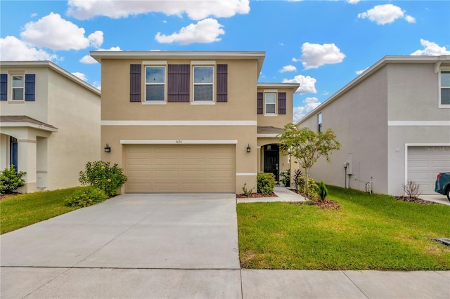 view of property featuring a front yard and a garage