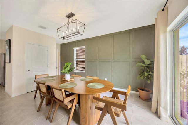 dining space with a chandelier and light tile patterned floors