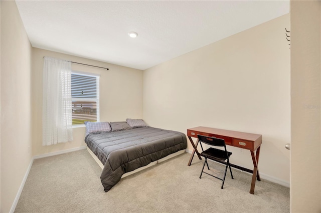 bedroom with light colored carpet